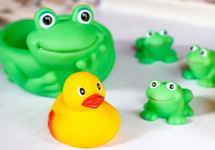 Child bath toys on a white wooden surface