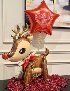 Inflatable reindeer balloon with red star balloon and festive decorations
